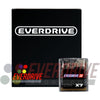 The image shows a black, glossy box with the Everdrive logo and "Everdrive GB X7" raised in white on the front. In front of the box is a dark grey, Game Boy cartridge-like device with smooth, matte finish and rounded edges. The box is sealed in plastic wrap.